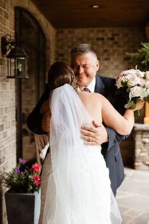A tender moment captured between a couple during their first look on their wedding day.