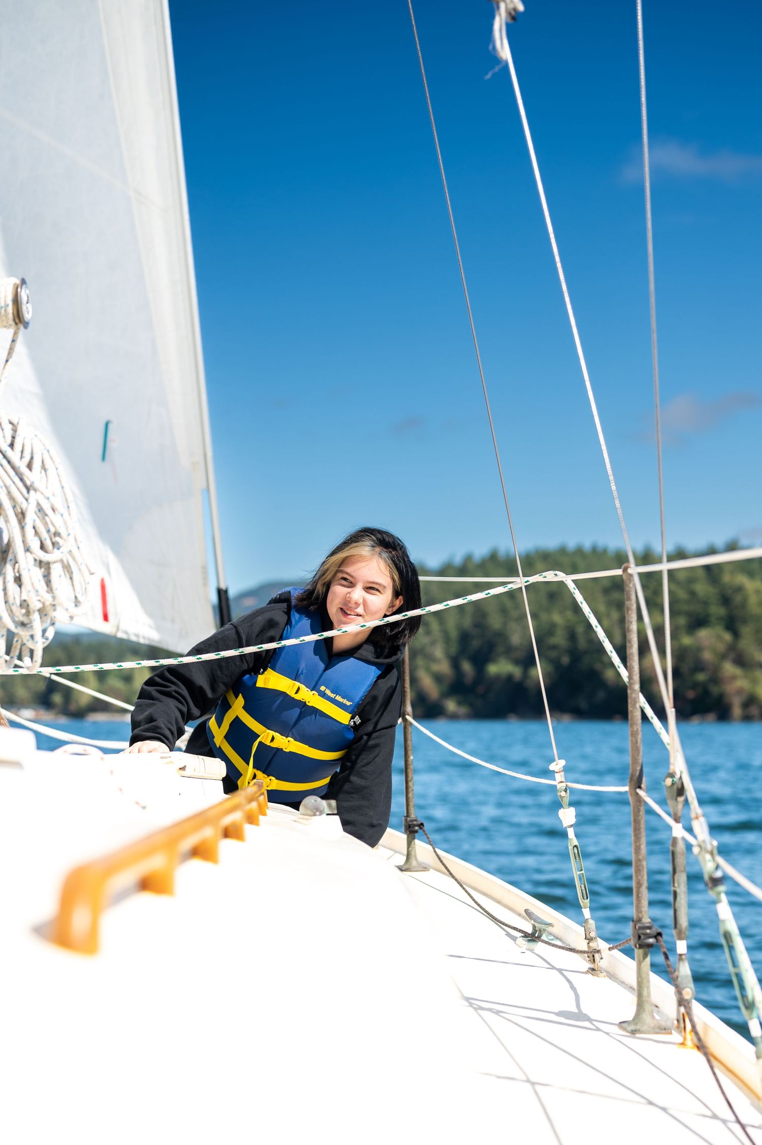 Young girl smiling for a photo shoot in the San Juan Islands by a Redmond Family Photographer