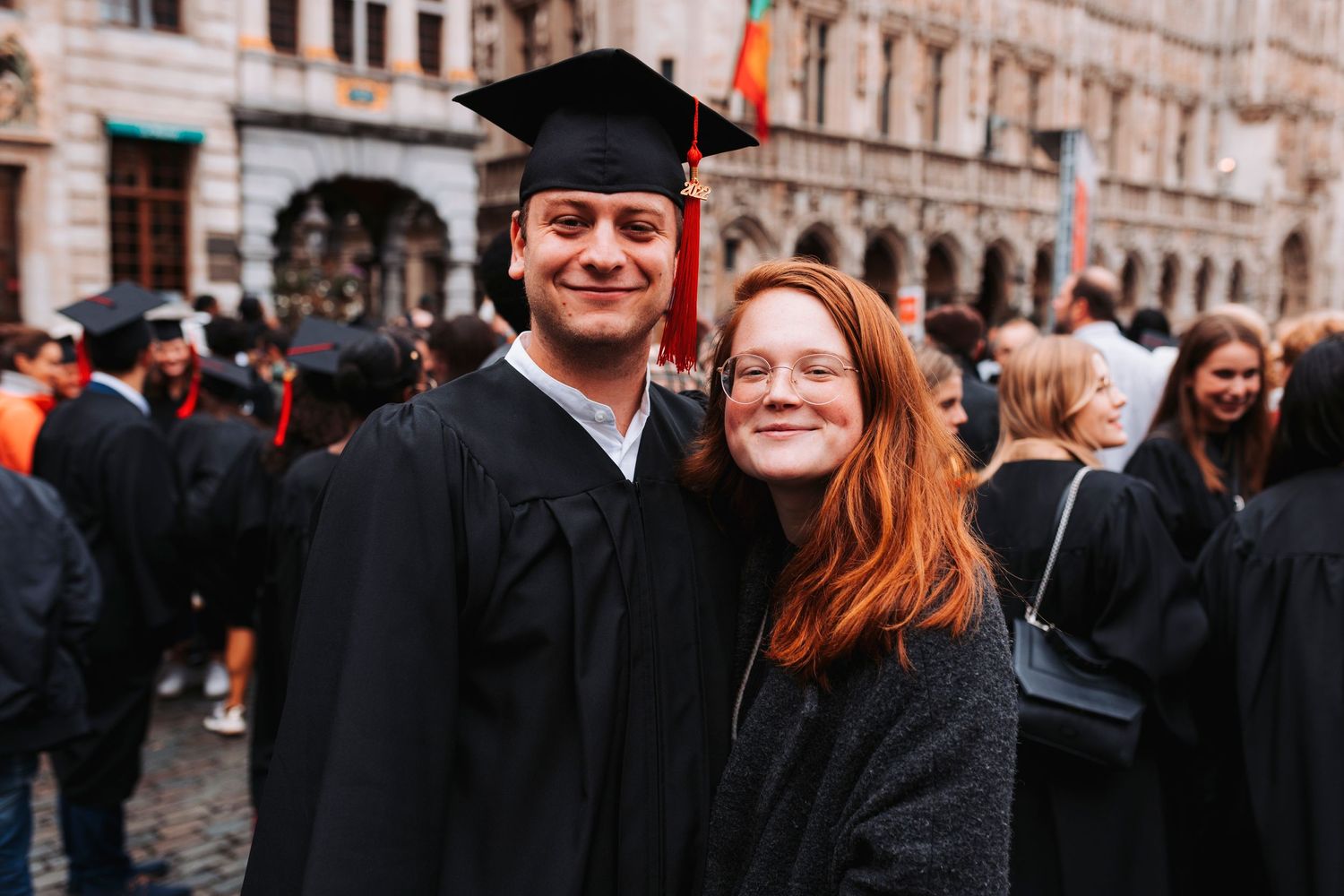 Graduation celebration with graduates in traditional caps and gowns.
