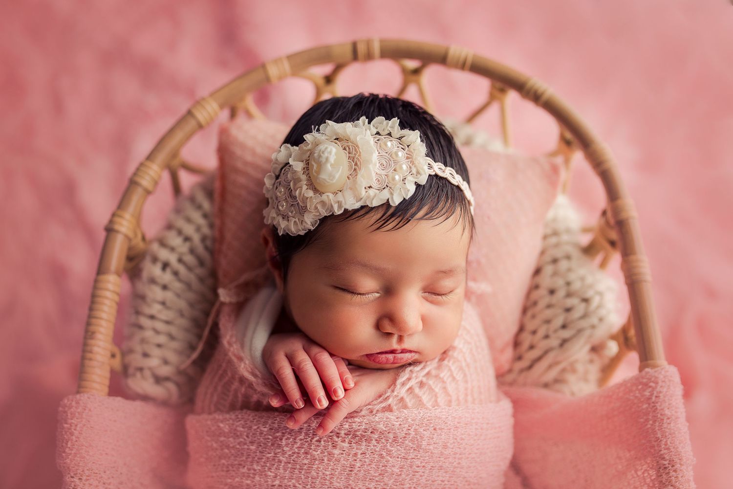 baby close up sleeping in basket pink clothing