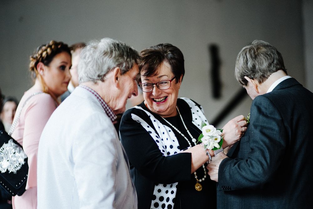 Small group sharing intimate moment during wedding celebration indoors.
