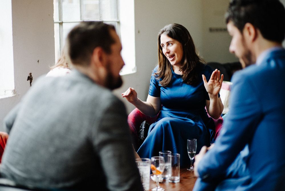 An animated conversation between friends in a casual indoor setting.