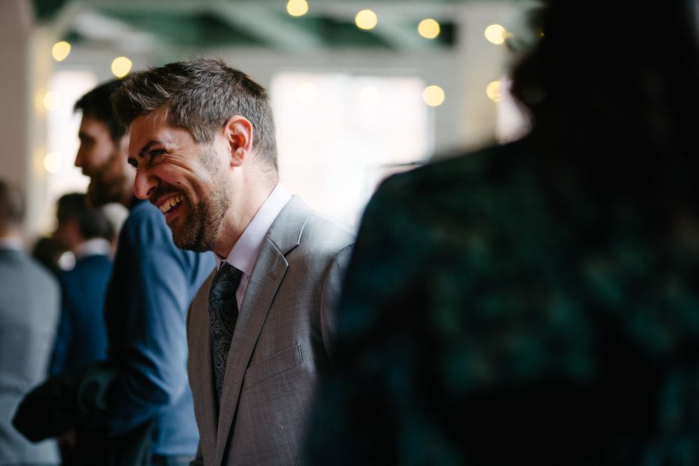 A candid moment at a celebratory event with string lights in the background.