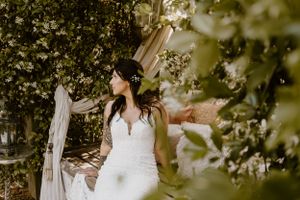 Bride in a wedding dress looking away at the Bella sera gardens wedding venue in loxely, Alabama