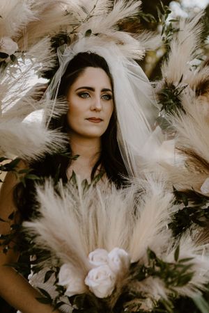 Bride surrounded by pompass grass bridal bouquets at Triple T farms wedding venue in Fruitdale, Alabama
