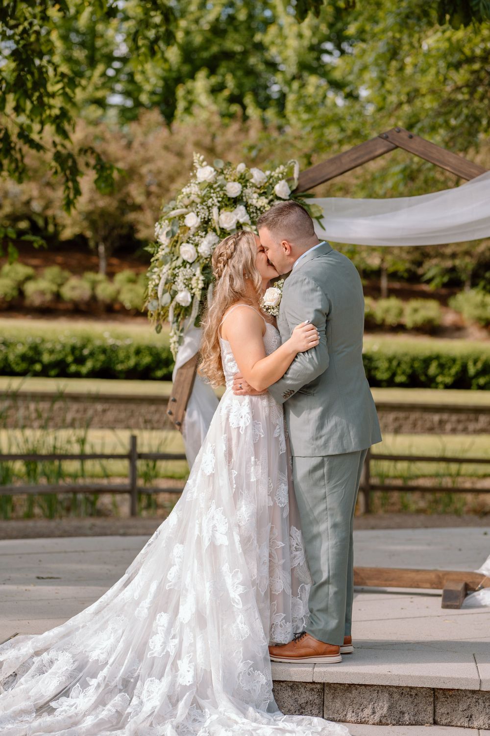 Bride and groom first kiss at front of ceremony