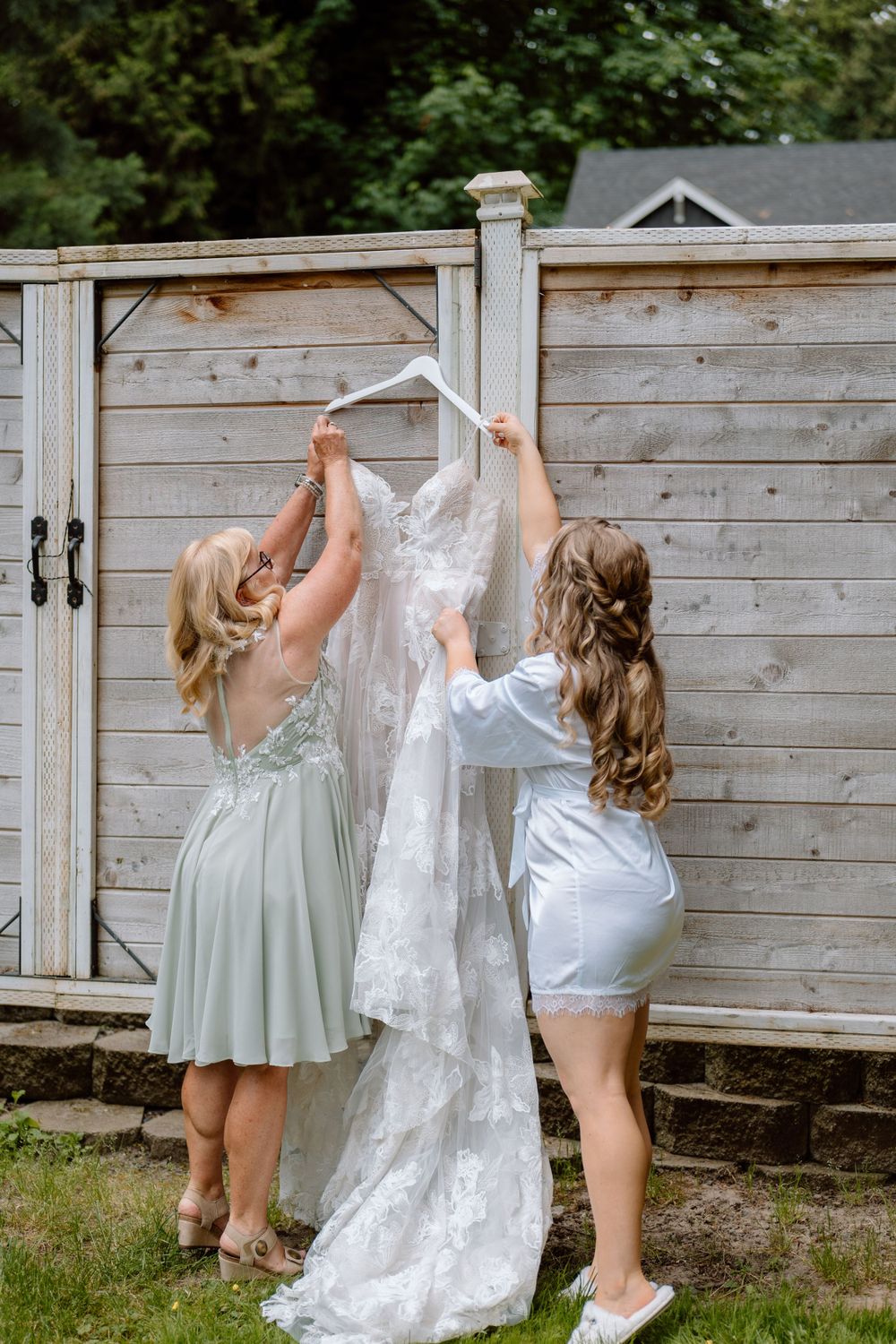 Bridesmaids bringing in wedding dress