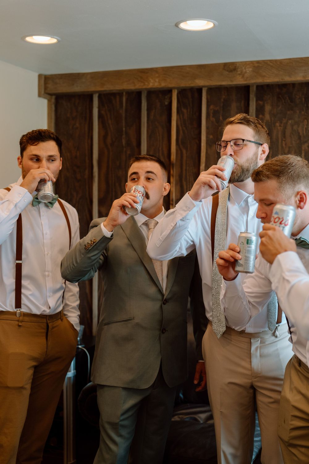Groom and groomsmen sharing a drink before ceremony
