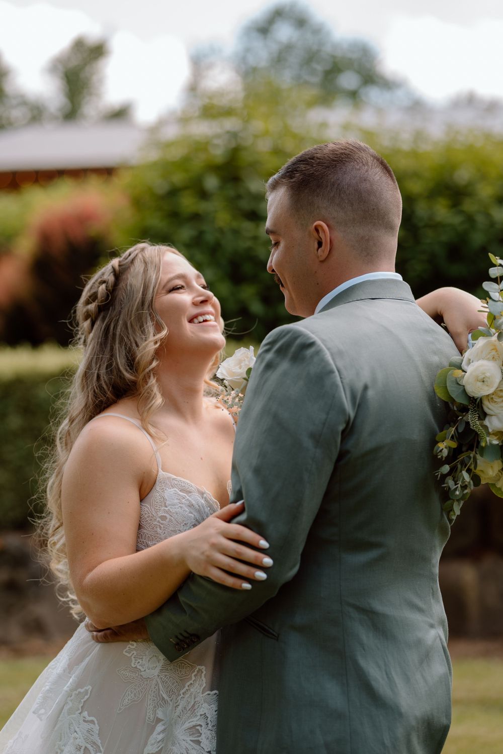 Bride and groom dancing in grass yard
