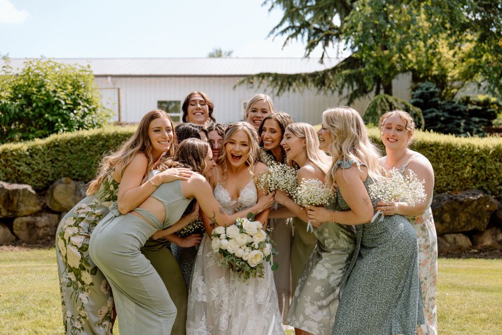 Bridesmaids gathered around bride and laughing