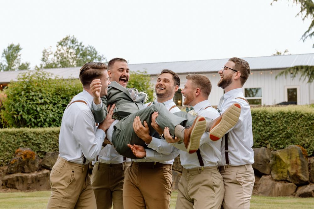 Groomsmen carrying Groom