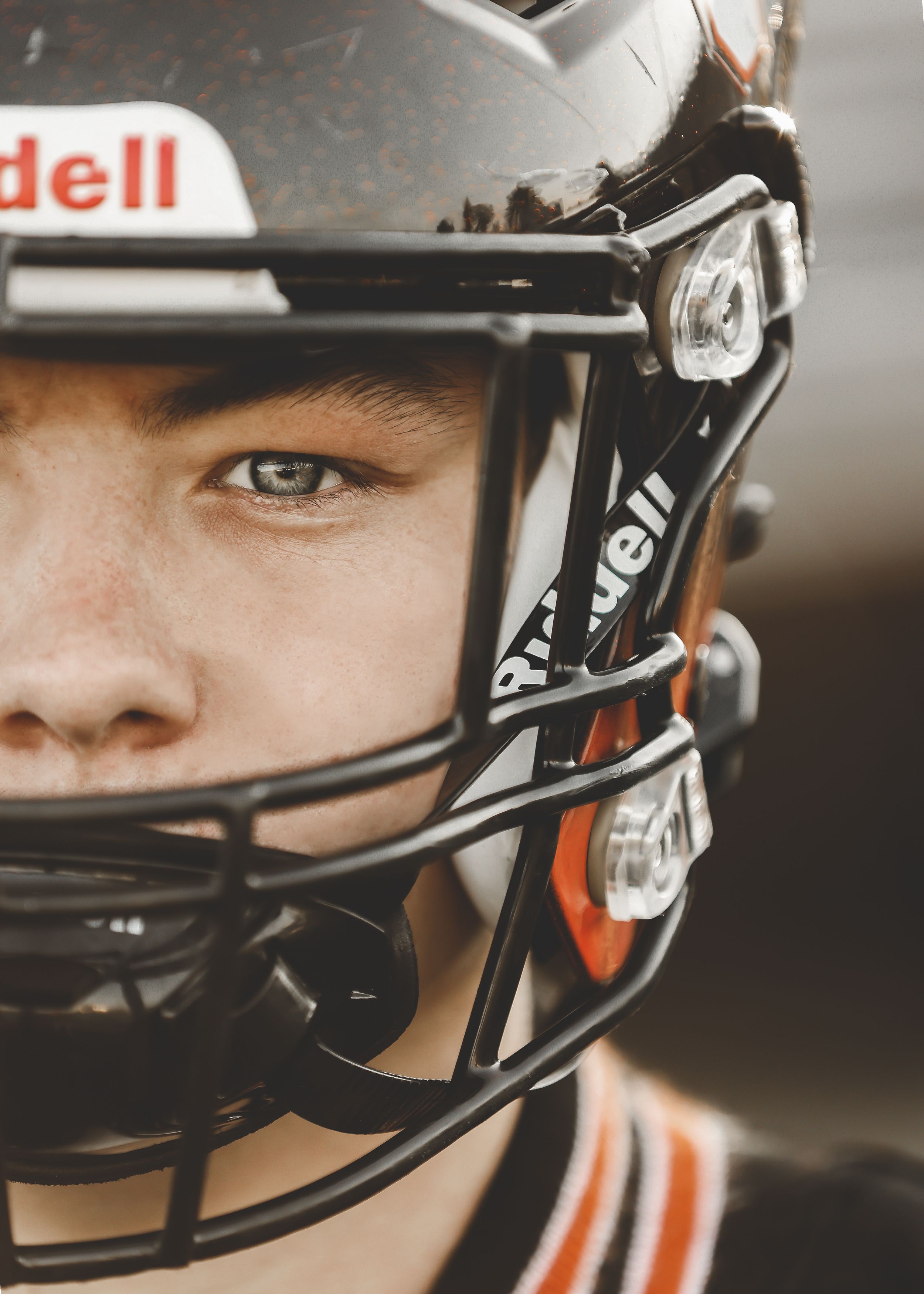 Side profile of athlete wearing Riddell football helmet.