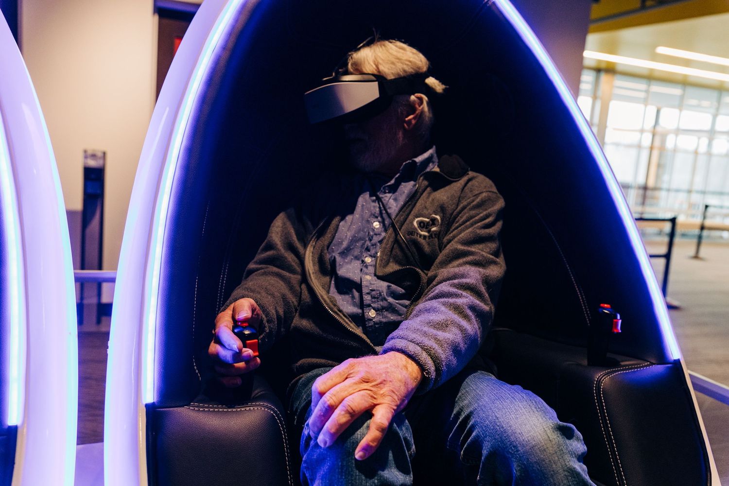 Man sitting in virtual reality game at Monroe Science Center