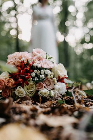 A beautiful wedding bouquet surrounded by nature's serenity in the enchanting woods.