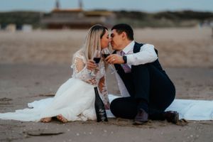 A beautiful moment captured: Newlyweds sharing a romantic kiss on the beach. Love and happiness in the air.