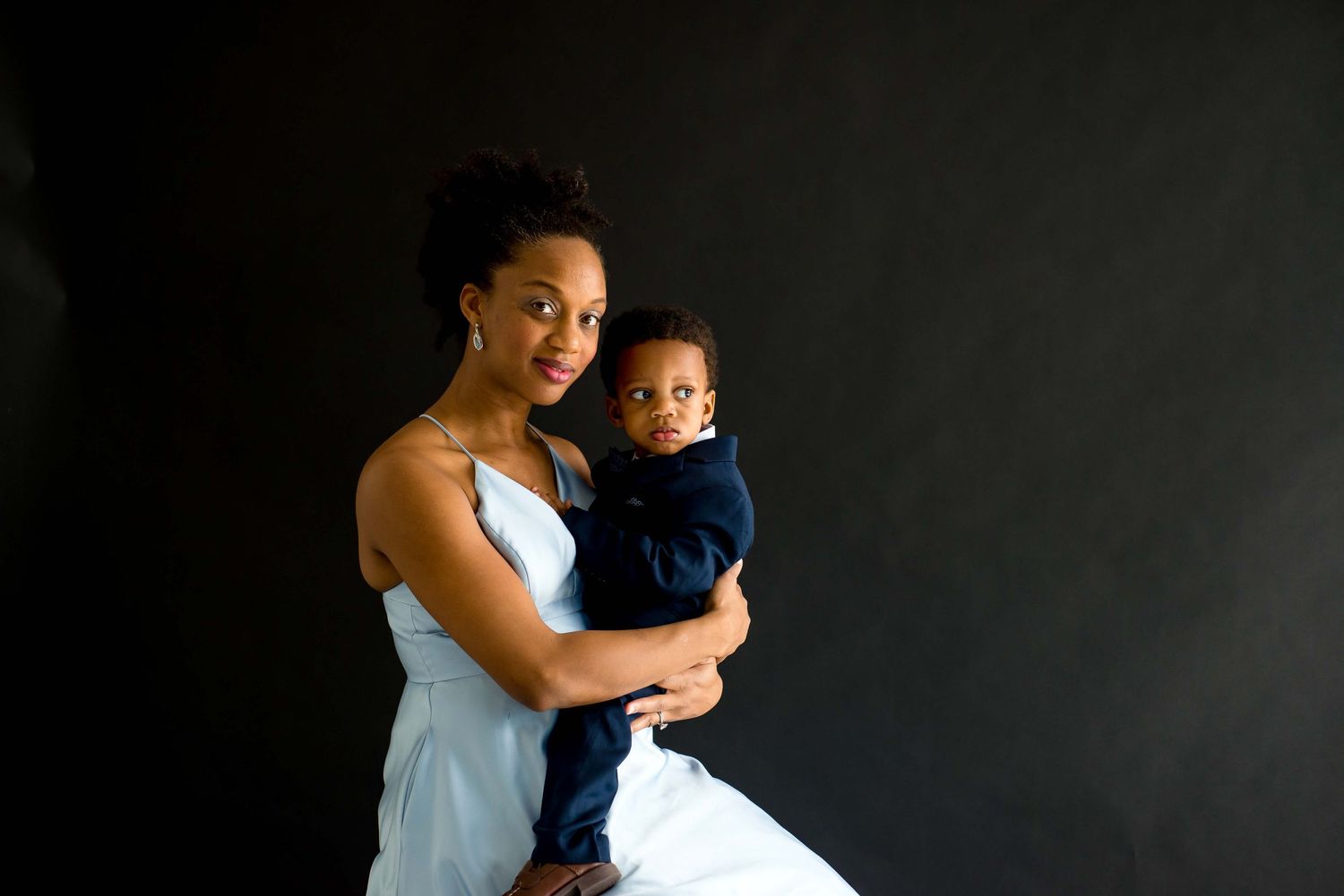 daughter and mother taking pictures together in a black studio houston texas