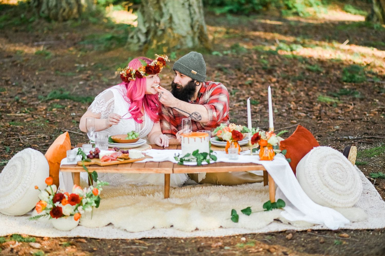 Bride and groom having picnic in forest. Photo by Tori Shults.