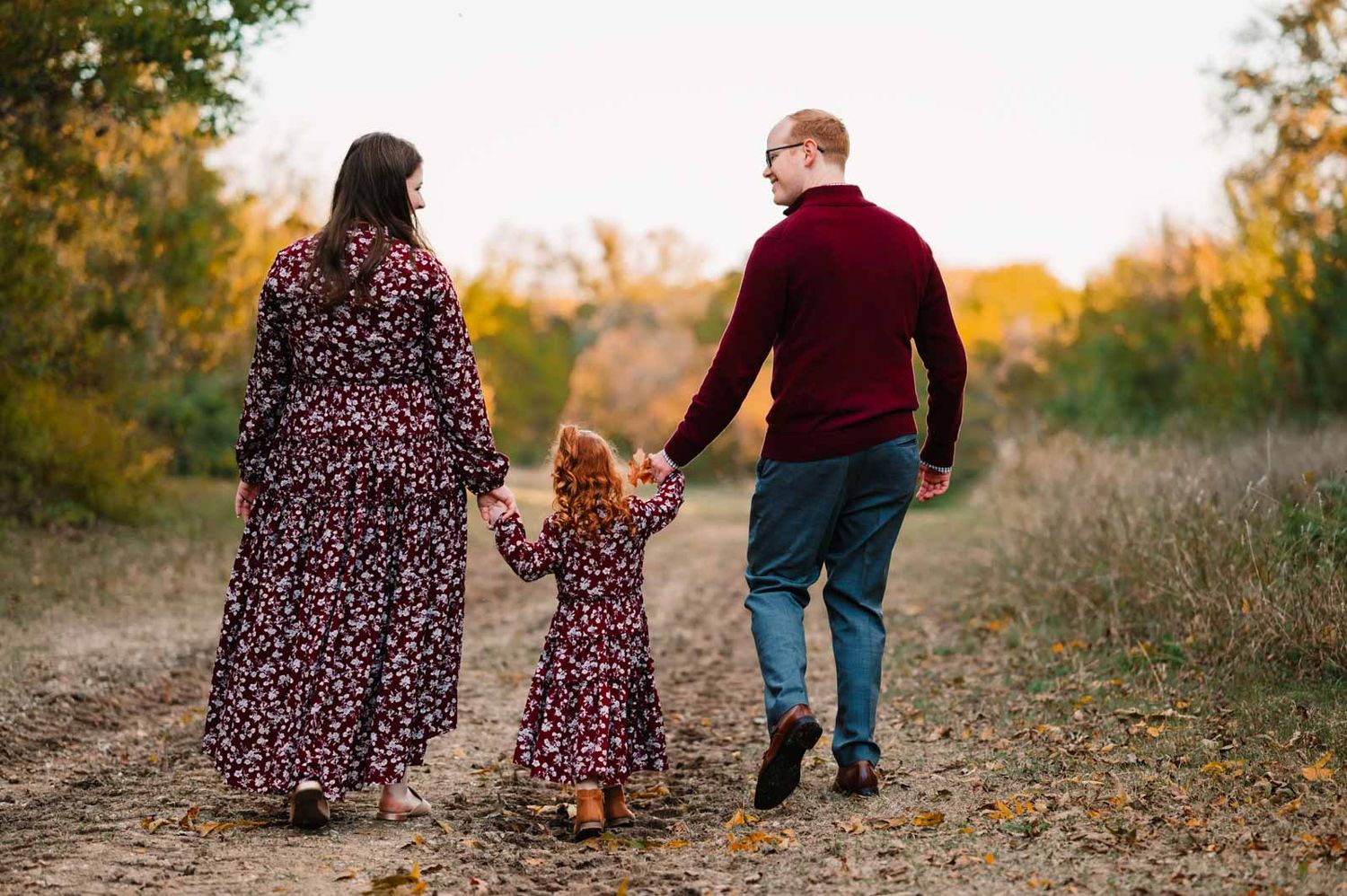 Couple walks away from camera holding hands of preschool aged daughter during dallas area Family Photo Session by mesquite, tx photographer