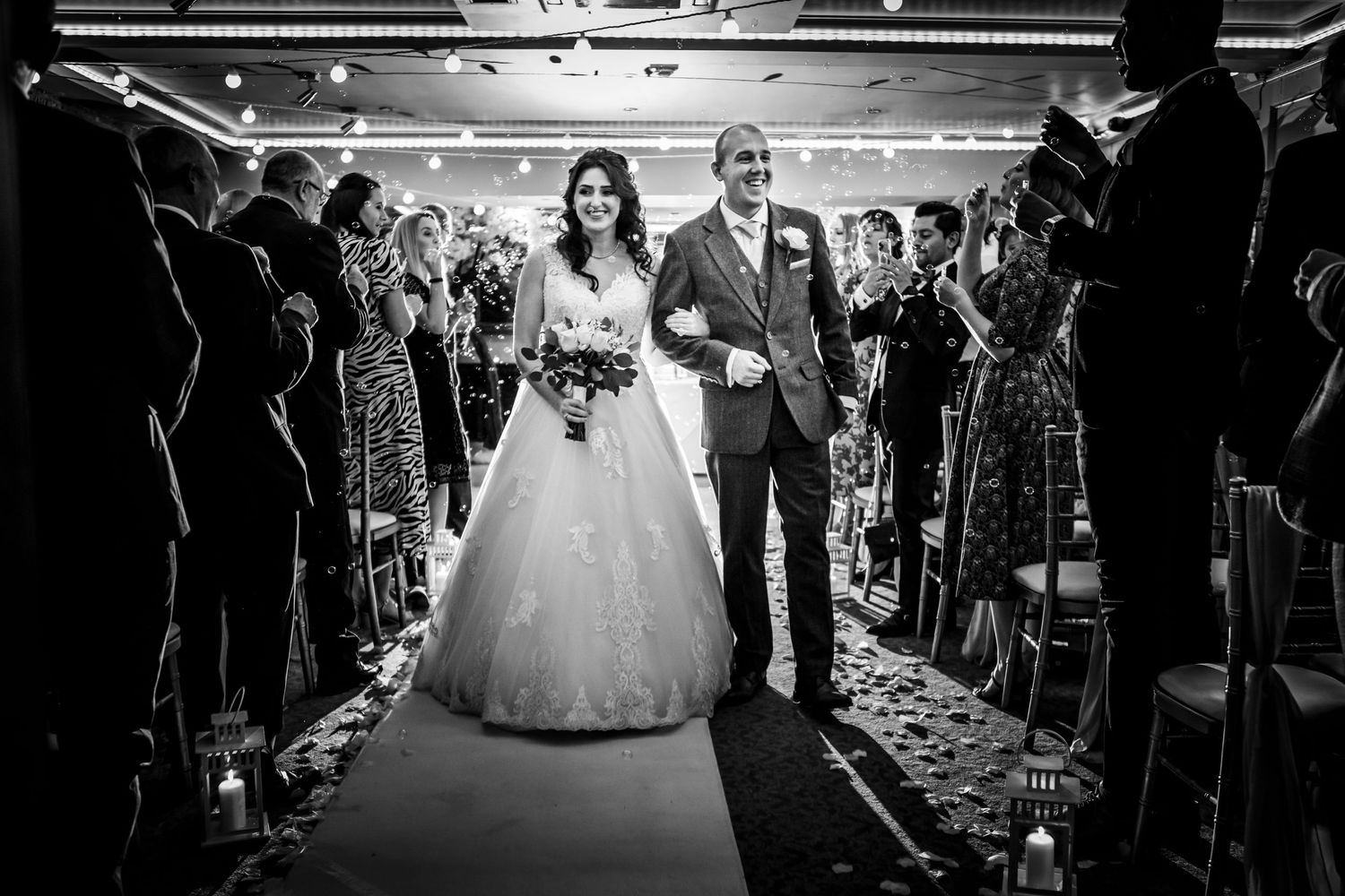 magic moments wedding photography walking the isle with guests blowing bubbles romantic