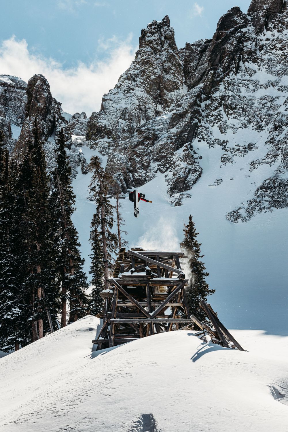 Jones Snowboards athlete Harry Kearney giant BS3 on a splitboard off the Alta Lakes Trestle in Telluride