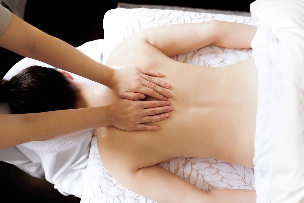 Professional massage therapist providing a relaxing treatment at an Adelaide wellness studio.