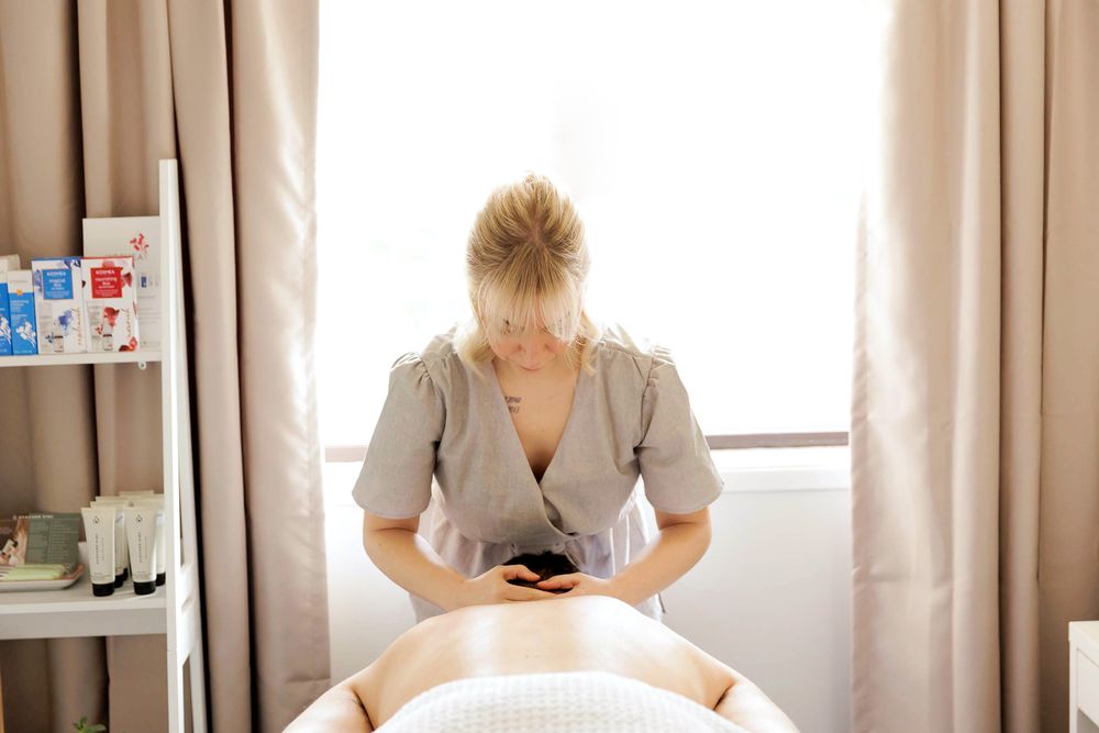 Professional massage therapist providing a relaxing treatment at an Adelaide wellness studio.