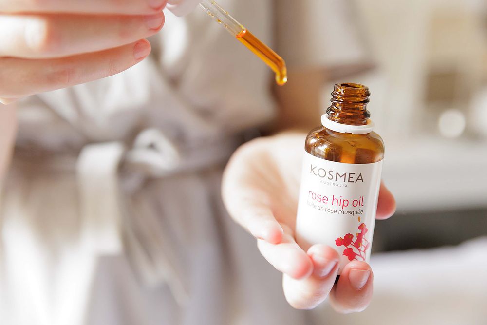 Close-up detail of essential massage oils and hot stones at an Adelaide remedial massage clinic.