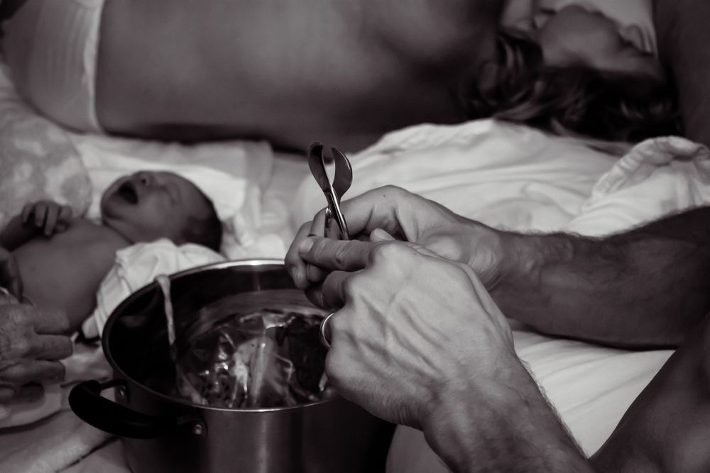 Black and white medical procedure documentation during birth.