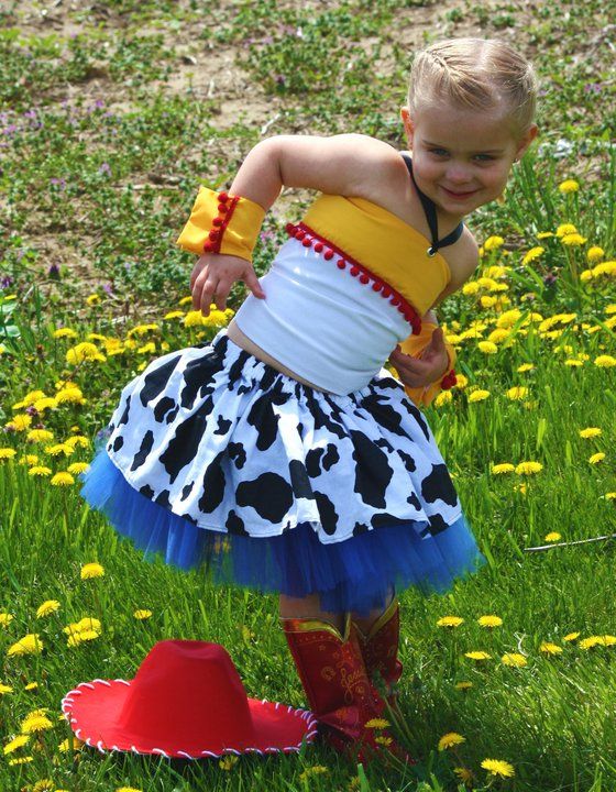 Dress with cow print pattern and red boots dancing among yellow dandelions.
