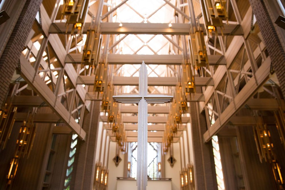 Architectural details of a grand chapel interior with wooden beams and warm lighting.