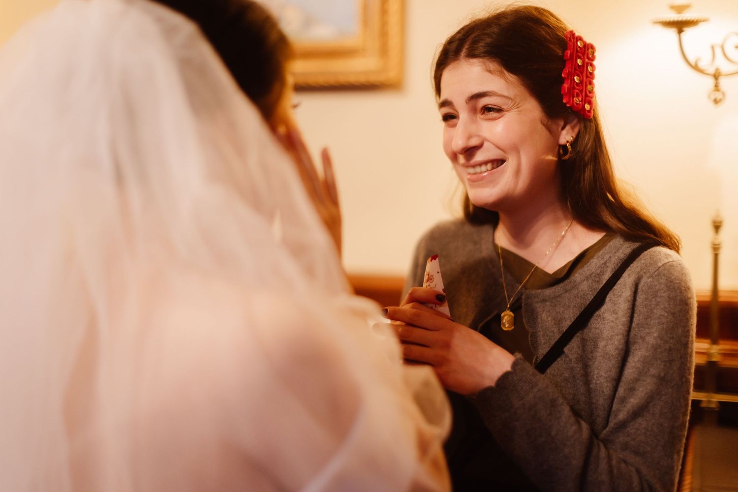 A joyful moment shared during wedding preparations in a warmly lit room.