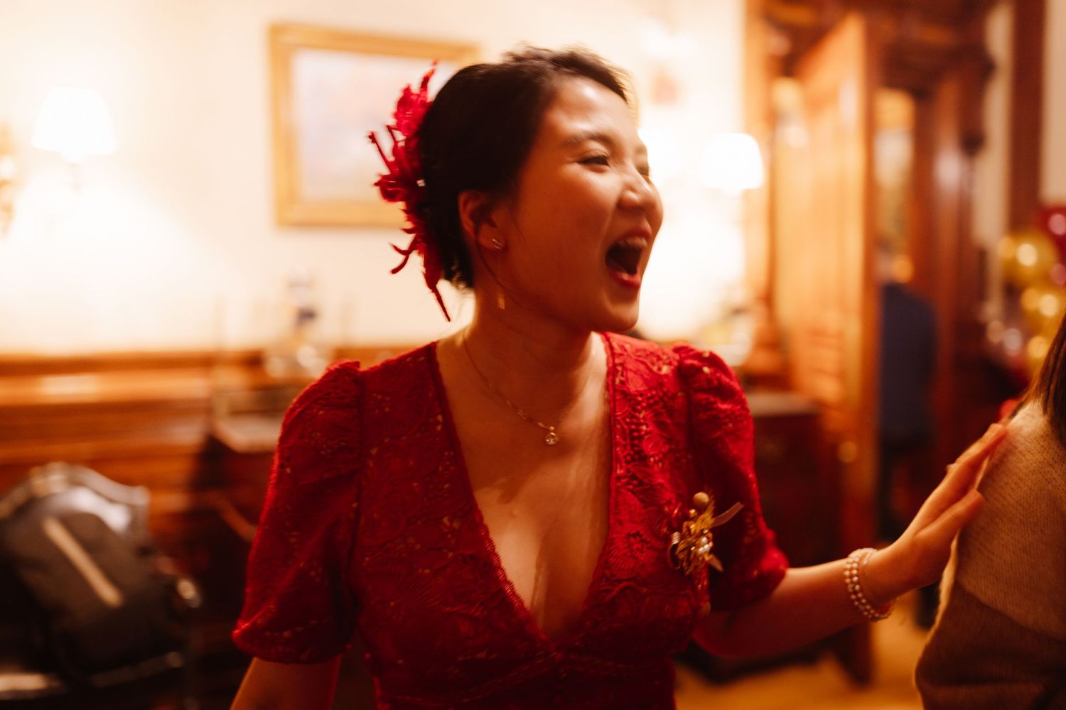 A celebratory moment captured in warm lighting with red floral accents.