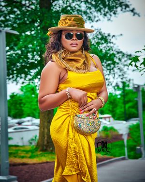 Vibrant yellow summer dress styled with straw hat and matching accessories.