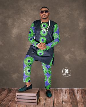 A stylish outfit featuring navy and green African print with modern design elements on wooden floor.