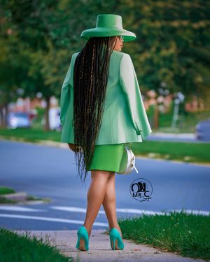 Street style shot featuring a mint green blazer and matching dress with coordinating ankle boots.