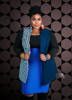 Fashionable portrait featuring houndstooth and blue color-block jacket with coordinating skirt.