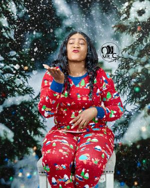 Winter portrait of someone wearing red holiday pajamas with falling snow effect.