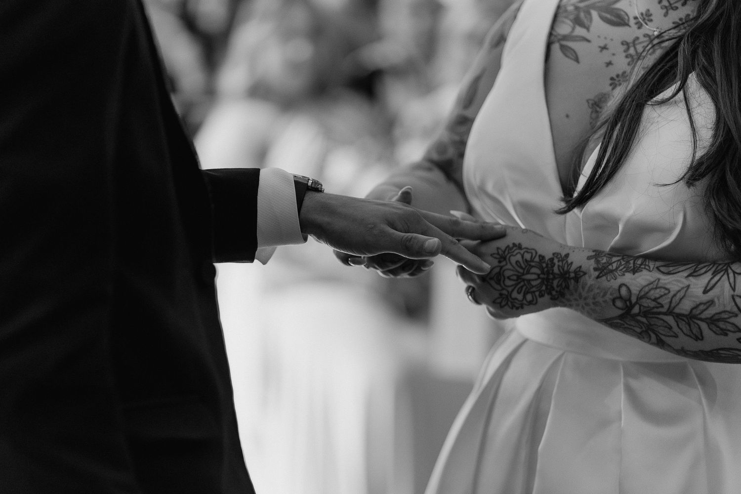 a close up a couple exchanging rings during their wedding ceremony.