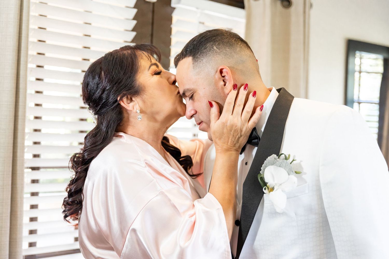 Intimate moment shared between couple during wedding preparations.