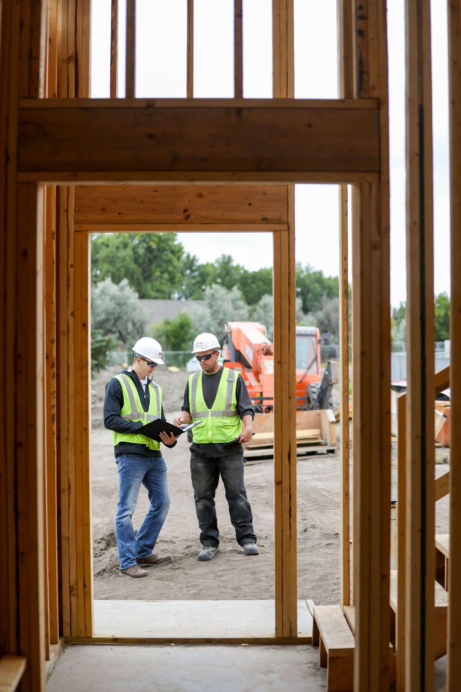 Interior framing of new home construction viewed through wooden wall studs.