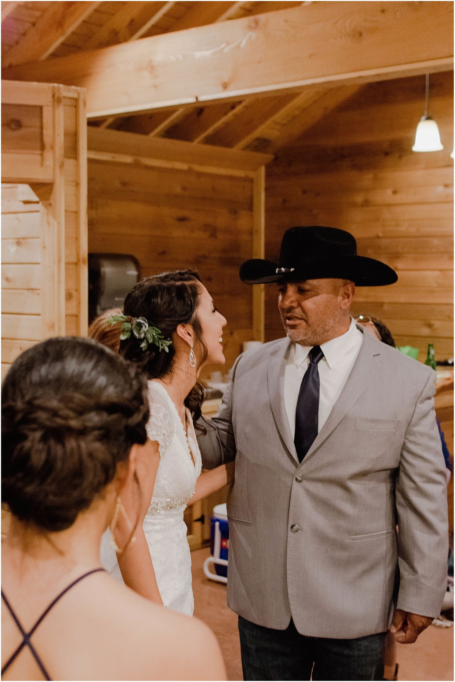 Wedding celebration moment in rustic wooden interior with formal attire.