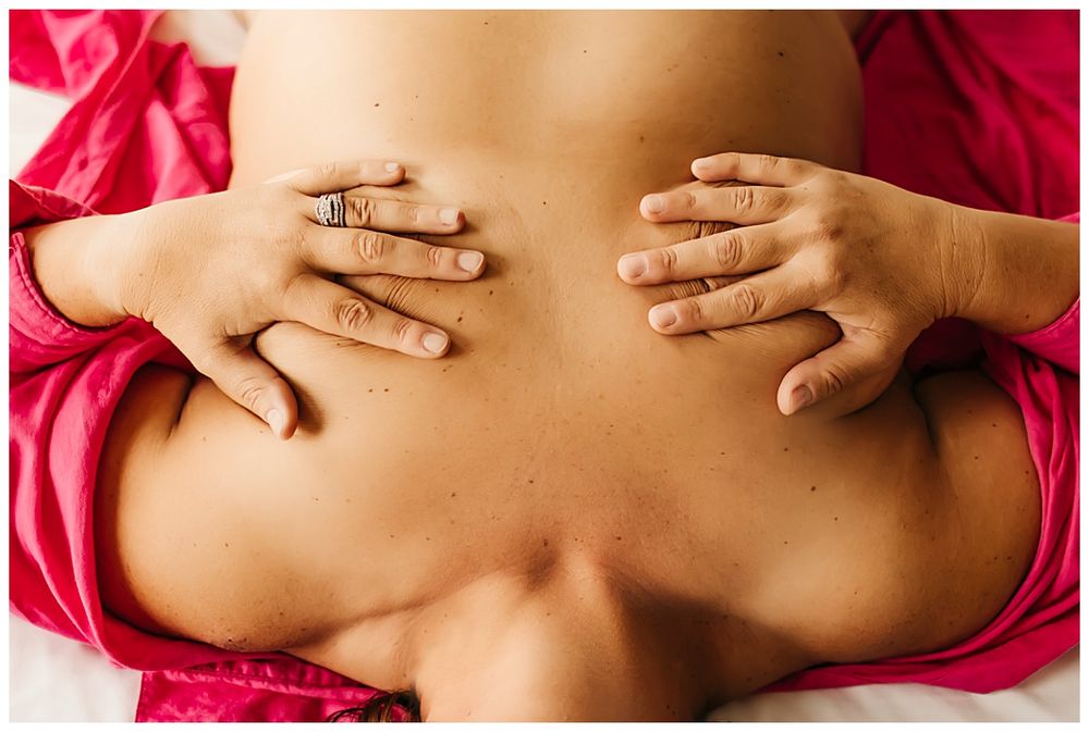 hands cover breasts during curvy boudoir session