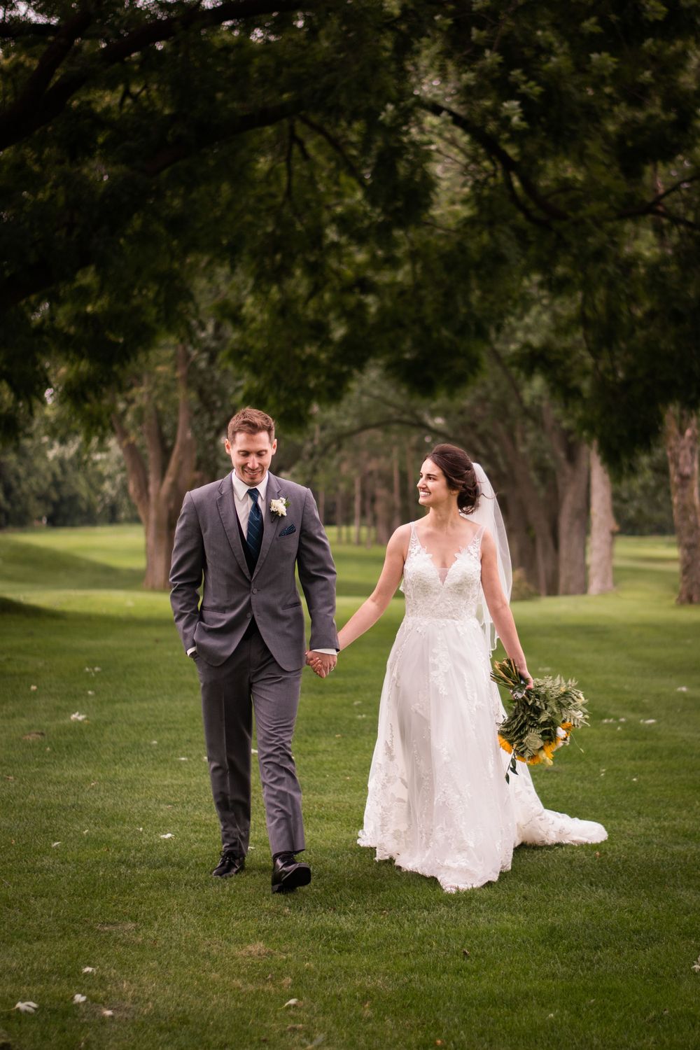 Bride and groom walking candid at Stratford Country Club wedding