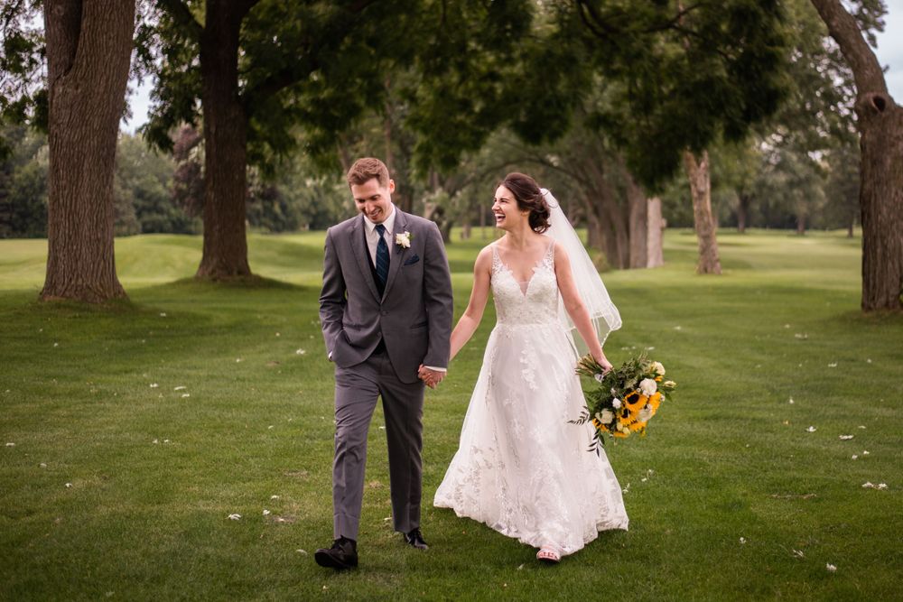 Bride and groom walking candid at Stratford Country Club wedding