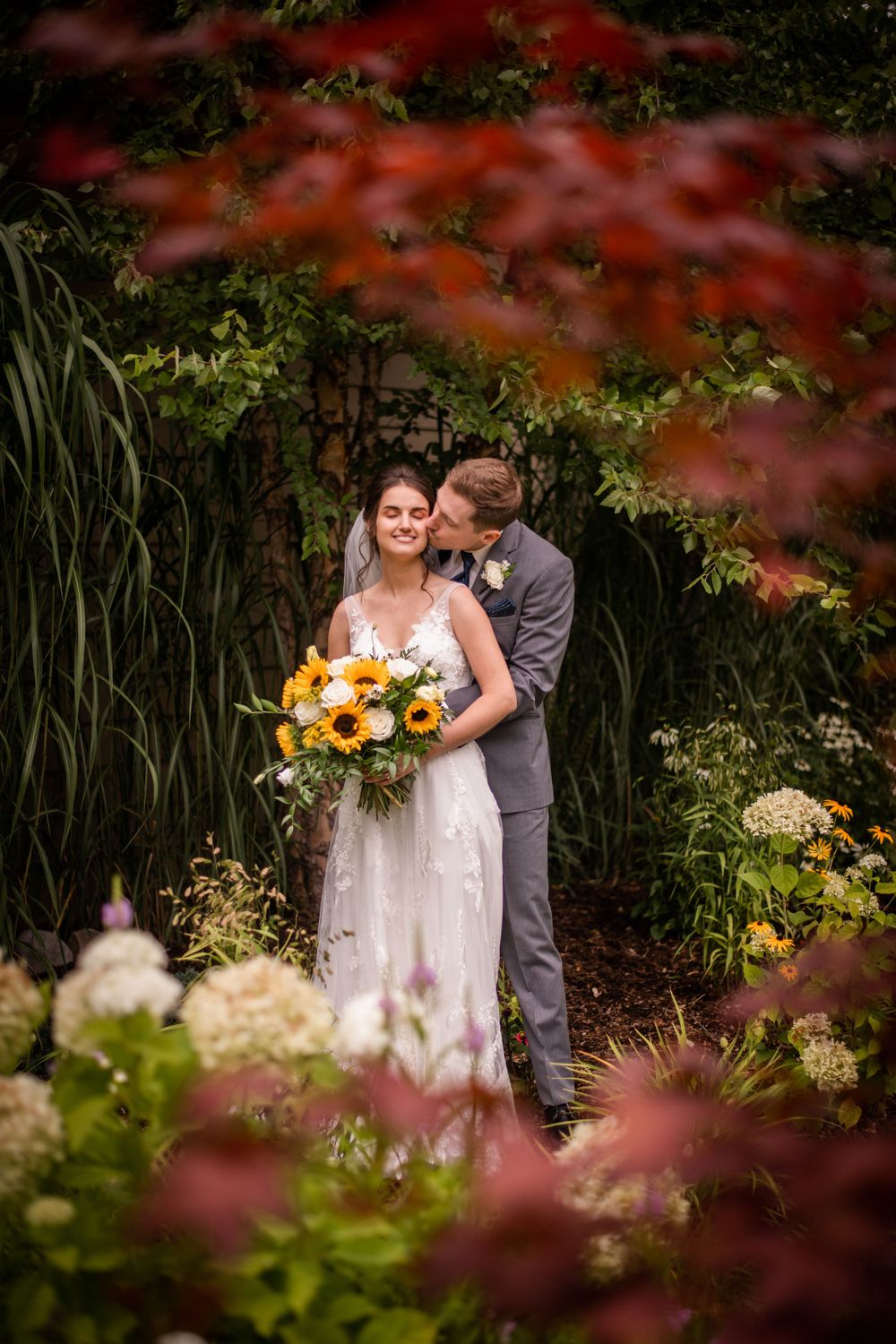 Bride and groom kissing in the garden at Stratford Country Club wedding