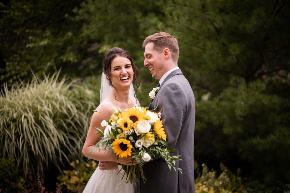 Bride and groom candid laughing photo outdoors at Stratford Country Club wedding