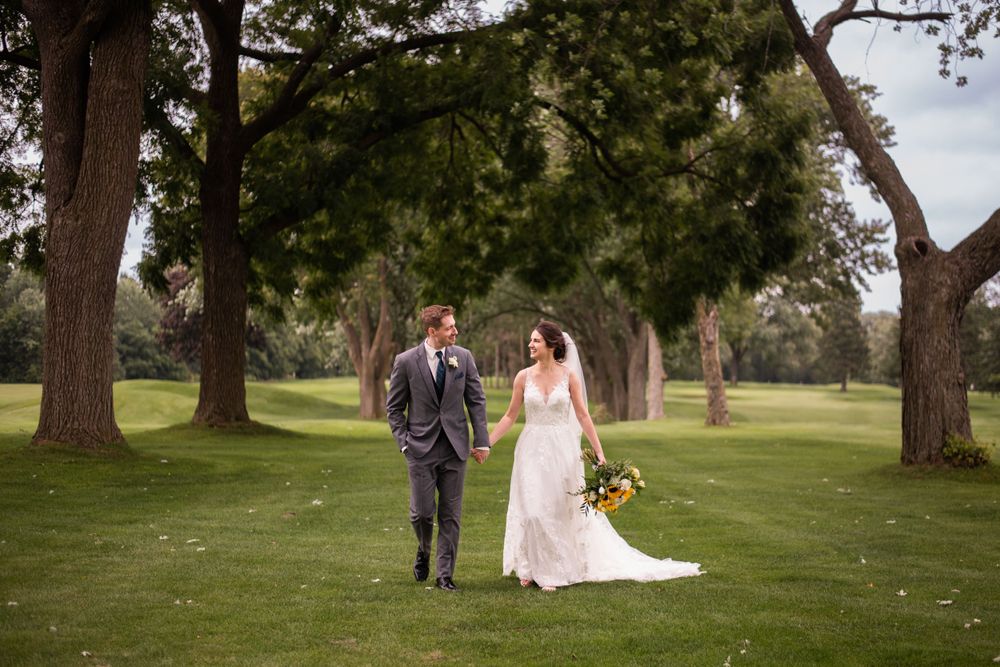 Bride and groom walking candid at Stratford Country Club wedding