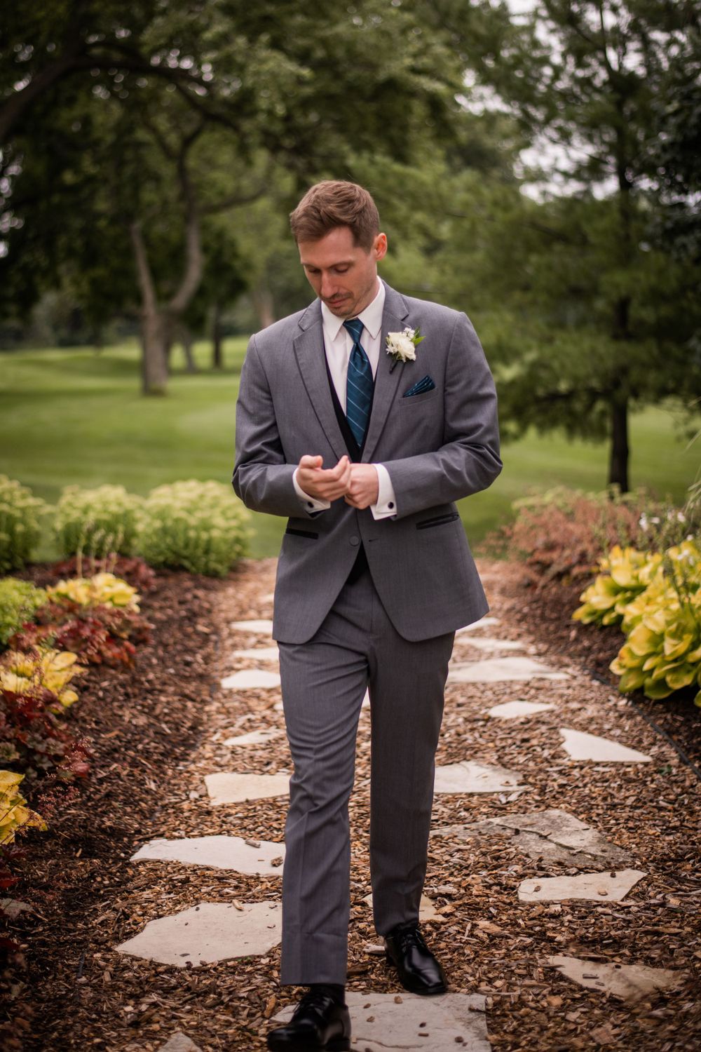 Groom portrait casual walking shot outdoors at Stratford Country Club wedding