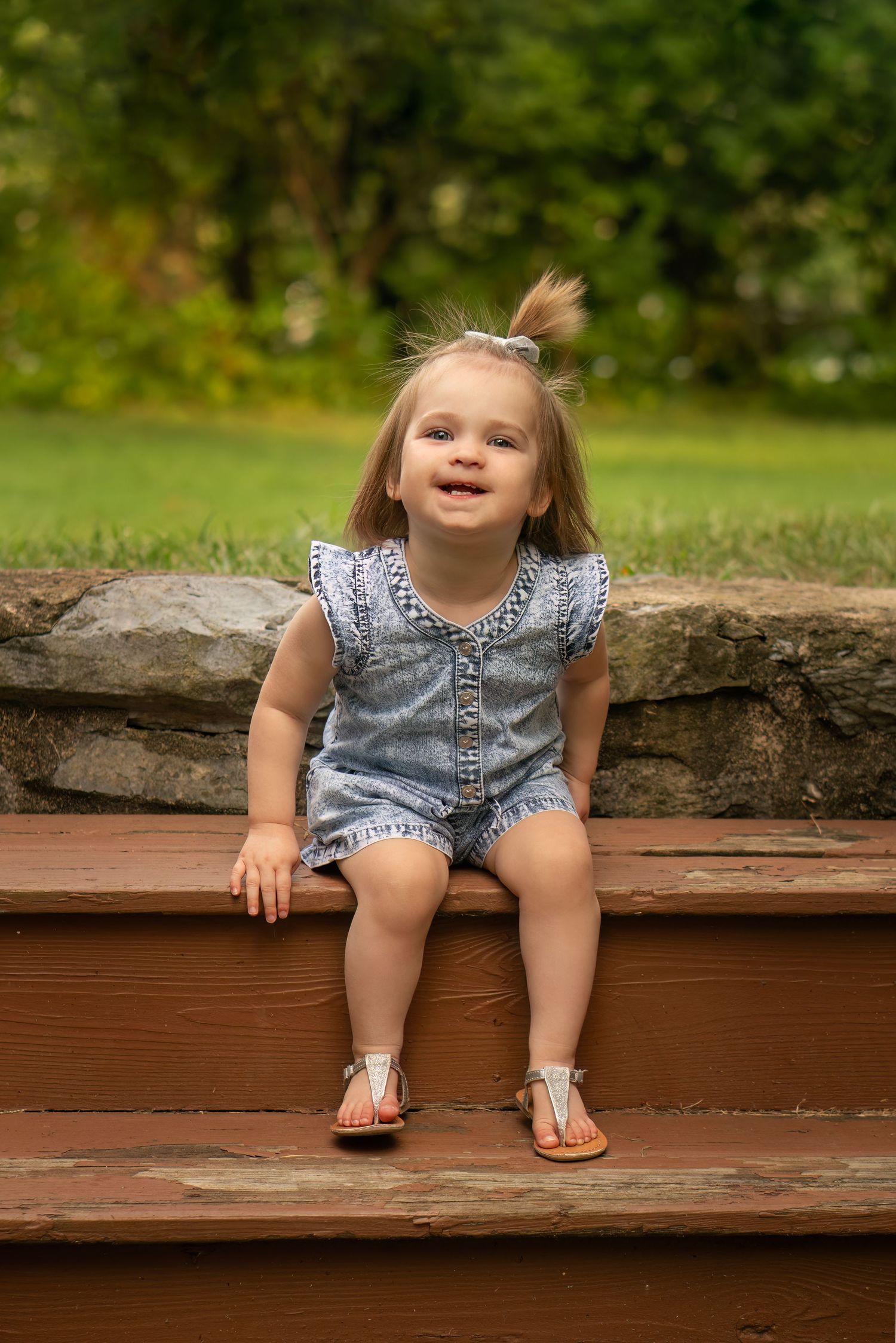 toddler poses on steps for photo