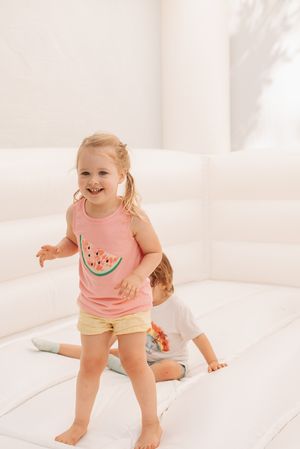 White bounce house or inflatable play area with light streaming in.